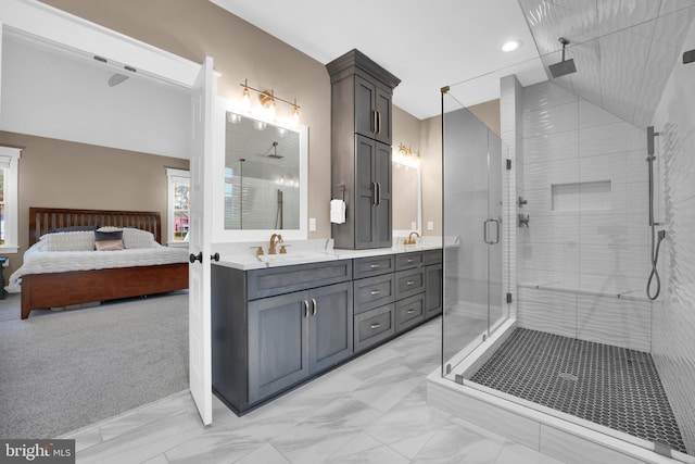 bathroom with vanity and a shower with door