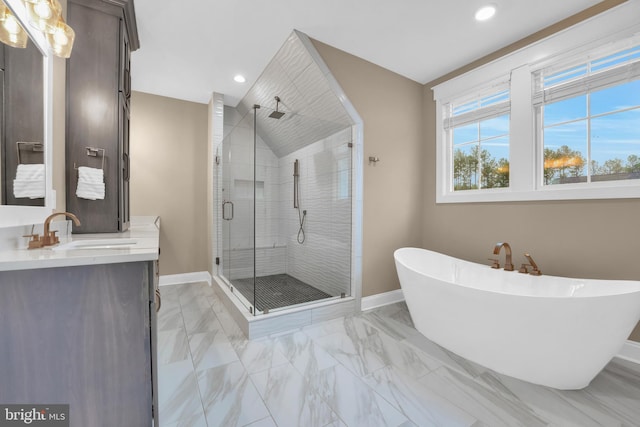 bathroom featuring vanity, independent shower and bath, and vaulted ceiling