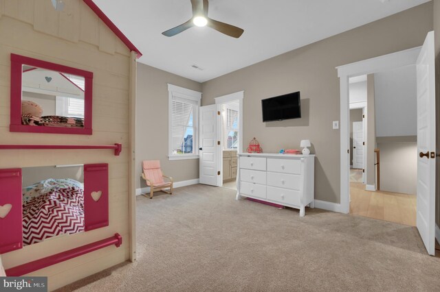 carpeted bedroom featuring ensuite bathroom and ceiling fan