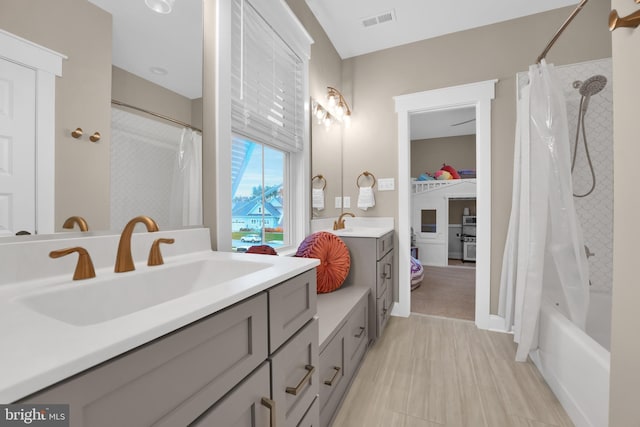 bathroom featuring vanity and shower / tub combo with curtain