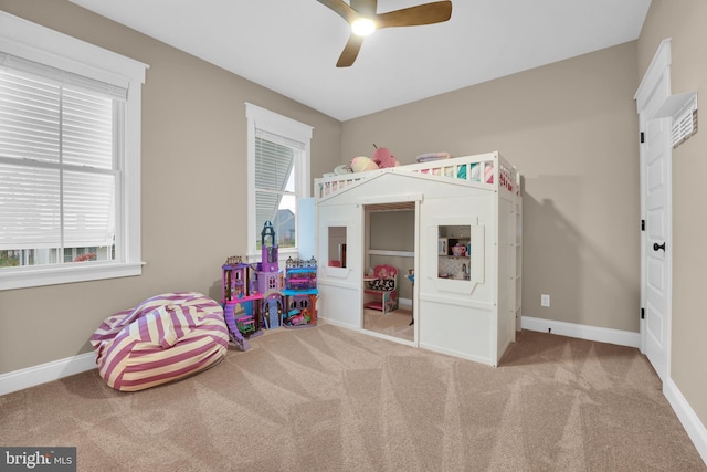 playroom with carpet floors and ceiling fan