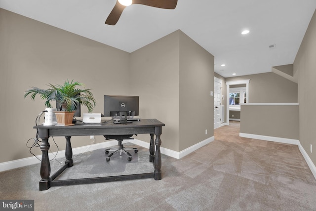 office space featuring ceiling fan and light carpet