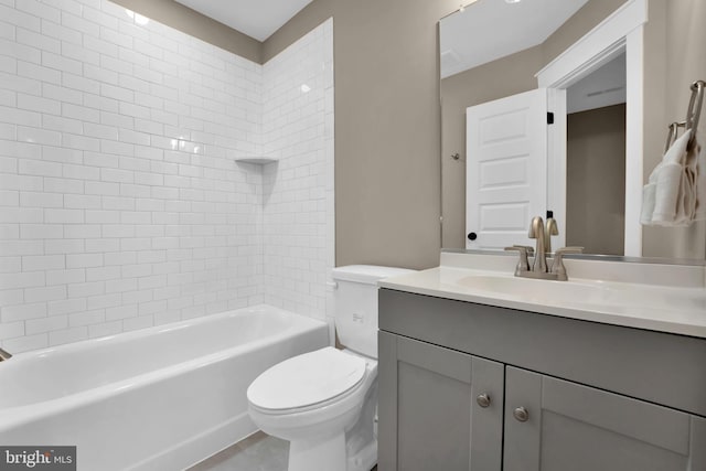 full bathroom featuring tiled shower / bath combo, toilet, and vanity