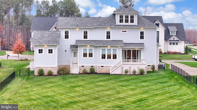 rear view of property with a lawn and cooling unit