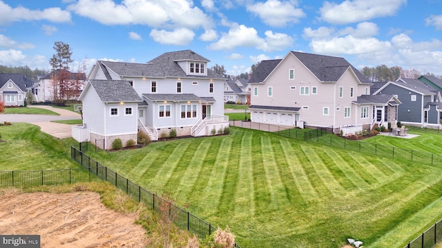 rear view of property with a lawn