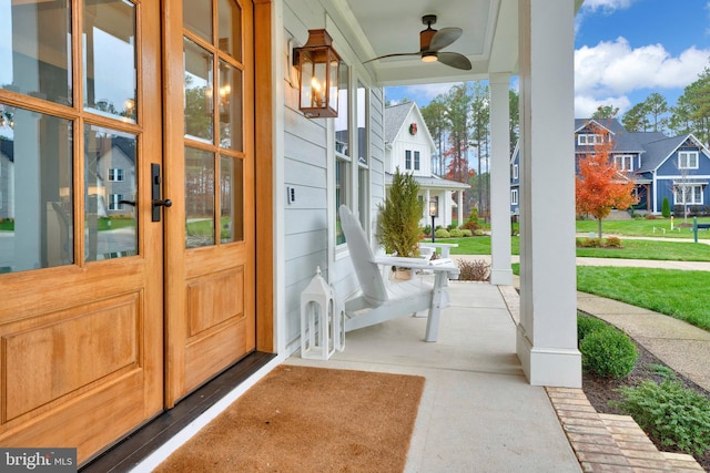 view of patio with ceiling fan and a porch