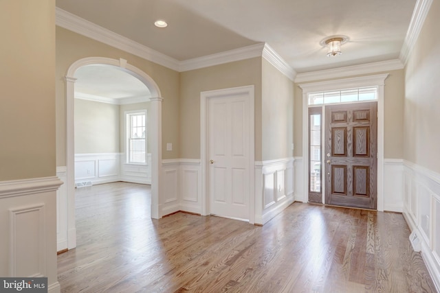 entryway with light hardwood / wood-style flooring and ornamental molding