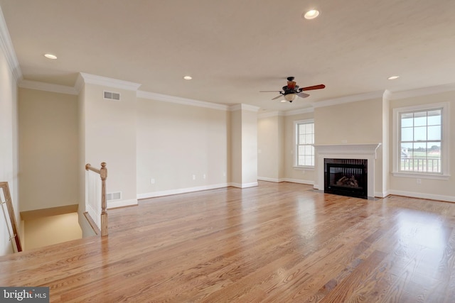 unfurnished living room with ceiling fan, crown molding, and light hardwood / wood-style flooring