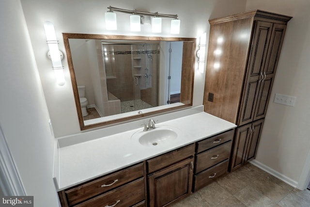 bathroom with vanity, toilet, and an enclosed shower