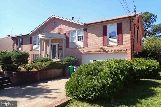 view of front of home featuring a balcony and a garage