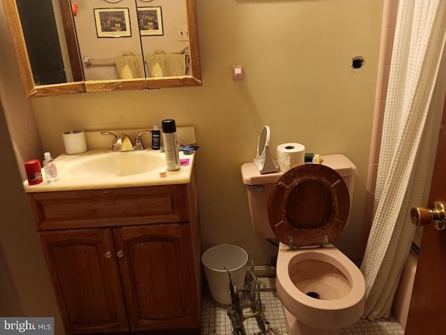 bathroom with toilet, walk in shower, tile patterned floors, and vanity