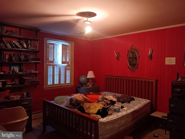 bedroom with crown molding and baseboard heating