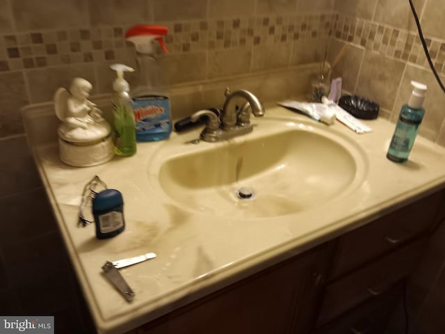 bathroom with decorative backsplash and vanity