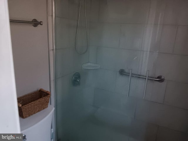 bathroom with a shower with door