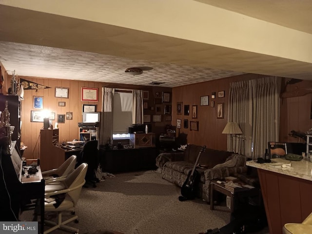 carpeted office space with wood walls and a textured ceiling