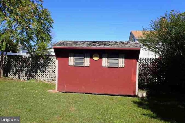 view of outbuilding with a lawn