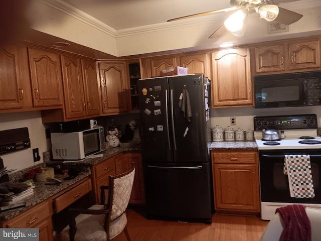 kitchen featuring black appliances, built in desk, dark stone counters, ornamental molding, and ceiling fan