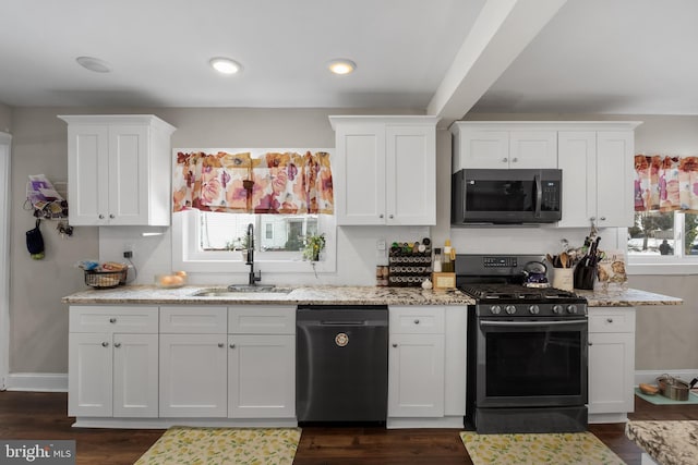 kitchen featuring sink, white cabinets, a healthy amount of sunlight, and stainless steel appliances