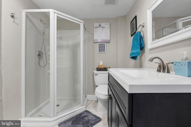 bathroom featuring a shower with shower door, toilet, and vanity