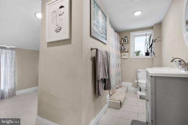 bathroom featuring toilet and vanity