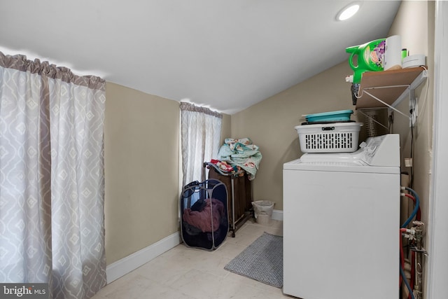 clothes washing area featuring washer and clothes dryer