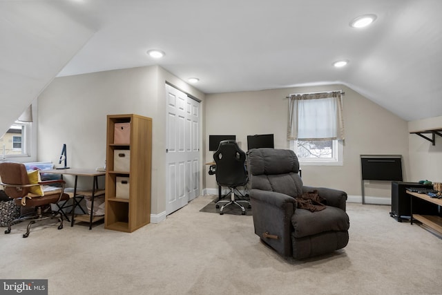 home office featuring a wealth of natural light, light colored carpet, and lofted ceiling