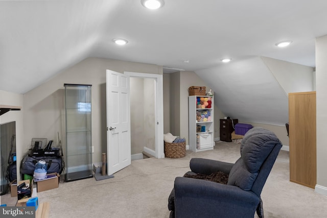 living area featuring carpet floors and lofted ceiling