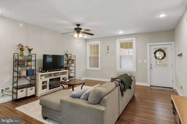 living room with ceiling fan and dark hardwood / wood-style floors