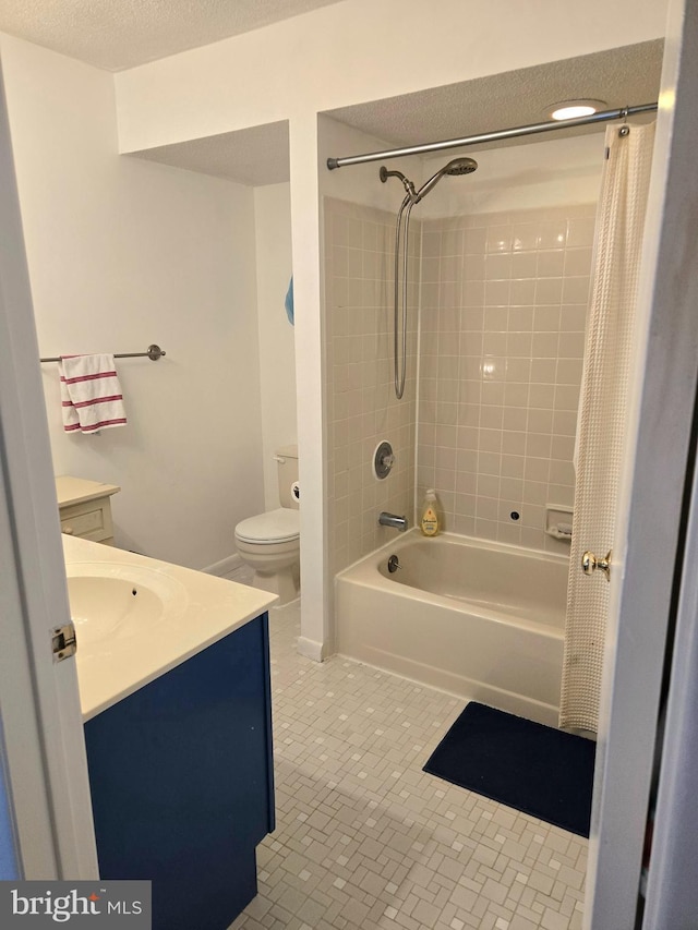 full bathroom with shower / washtub combination, tile patterned flooring, vanity, toilet, and a textured ceiling