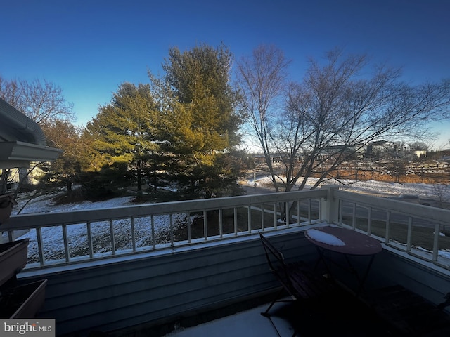 view of snow covered back of property