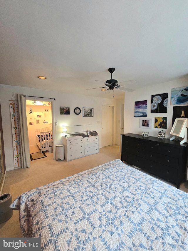 bedroom with light colored carpet and ceiling fan