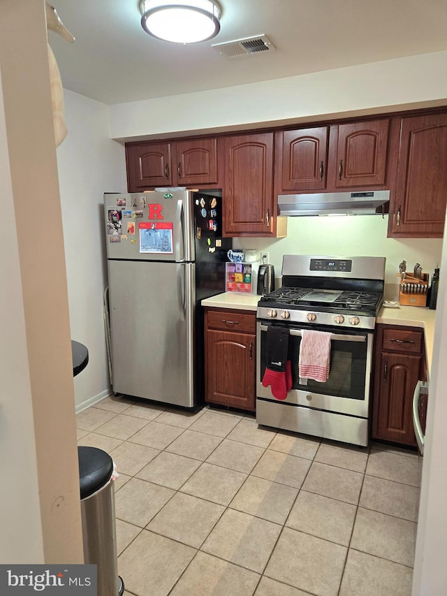 kitchen featuring appliances with stainless steel finishes and light tile patterned floors