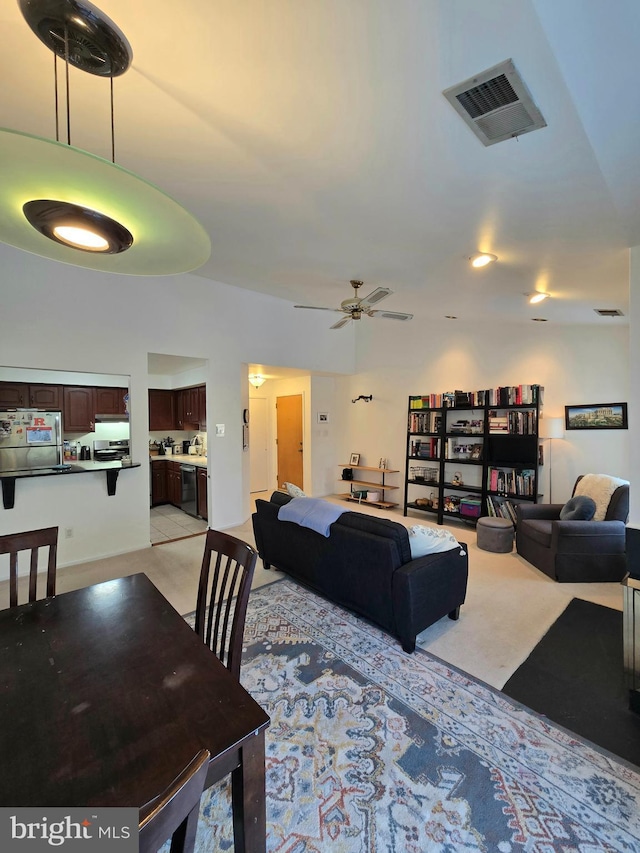 carpeted living room with ceiling fan