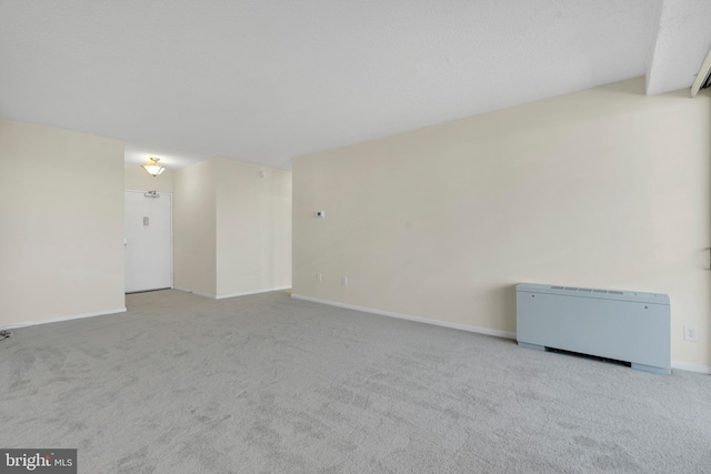 spare room featuring light colored carpet