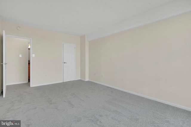 empty room featuring light colored carpet