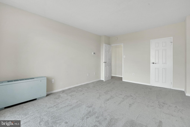 spare room featuring light colored carpet