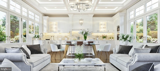 sunroom / solarium with coffered ceiling, a chandelier, and beamed ceiling