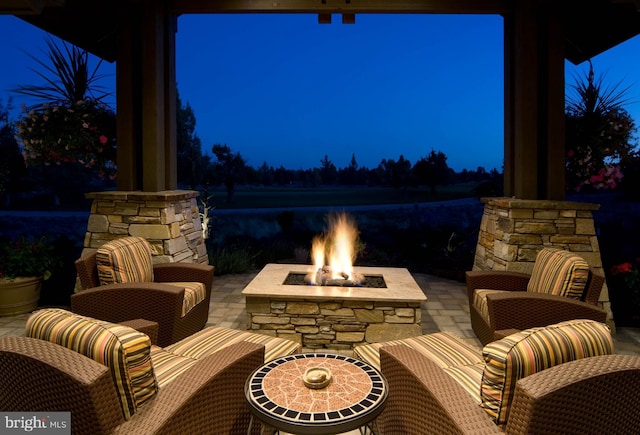 patio at night featuring a fire pit