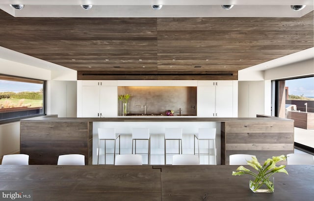 kitchen with white cabinets and wood ceiling