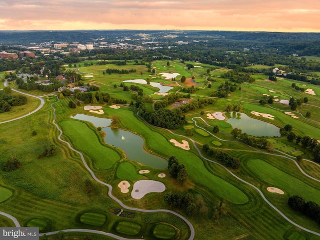 aerial view at dusk featuring a water view