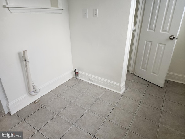 clothes washing area featuring light tile patterned floors