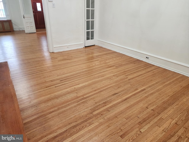 unfurnished room with light wood-type flooring