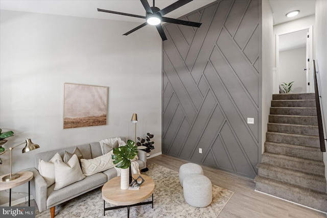 living room with light hardwood / wood-style floors and ceiling fan