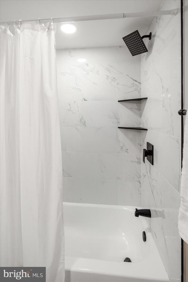 bathroom with shower / bath combo with shower curtain