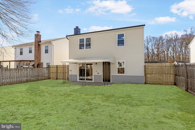 rear view of house with a yard and a patio area