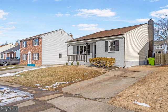 view of front of property with a front yard and covered porch