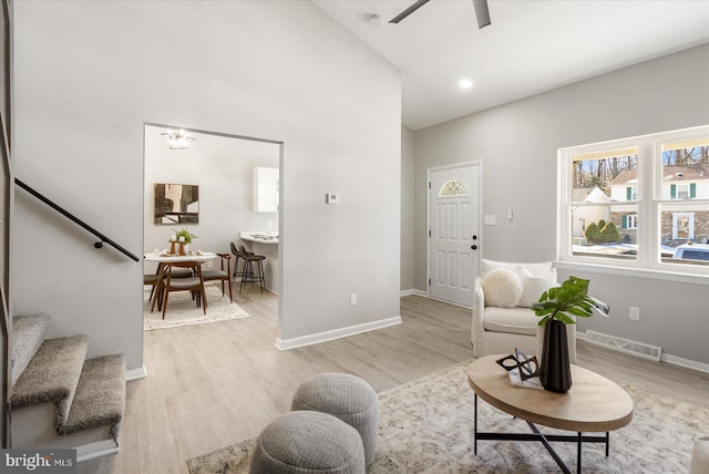 living room featuring ceiling fan and light wood-type flooring