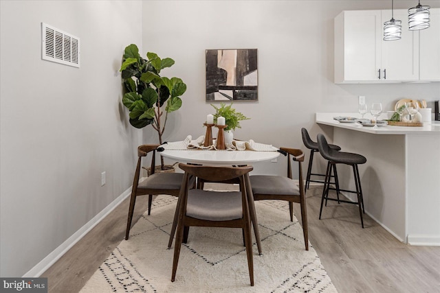 dining area with light hardwood / wood-style flooring