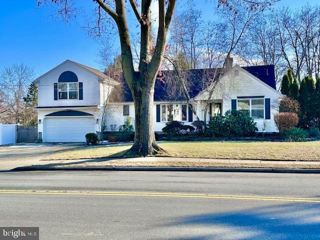 view of front of house with a garage and a front yard