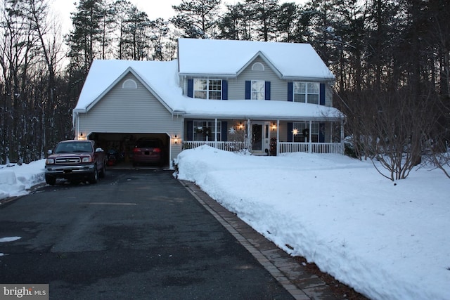 view of front of house with covered porch and a garage